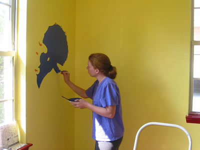 Alison painting a triceratops.
